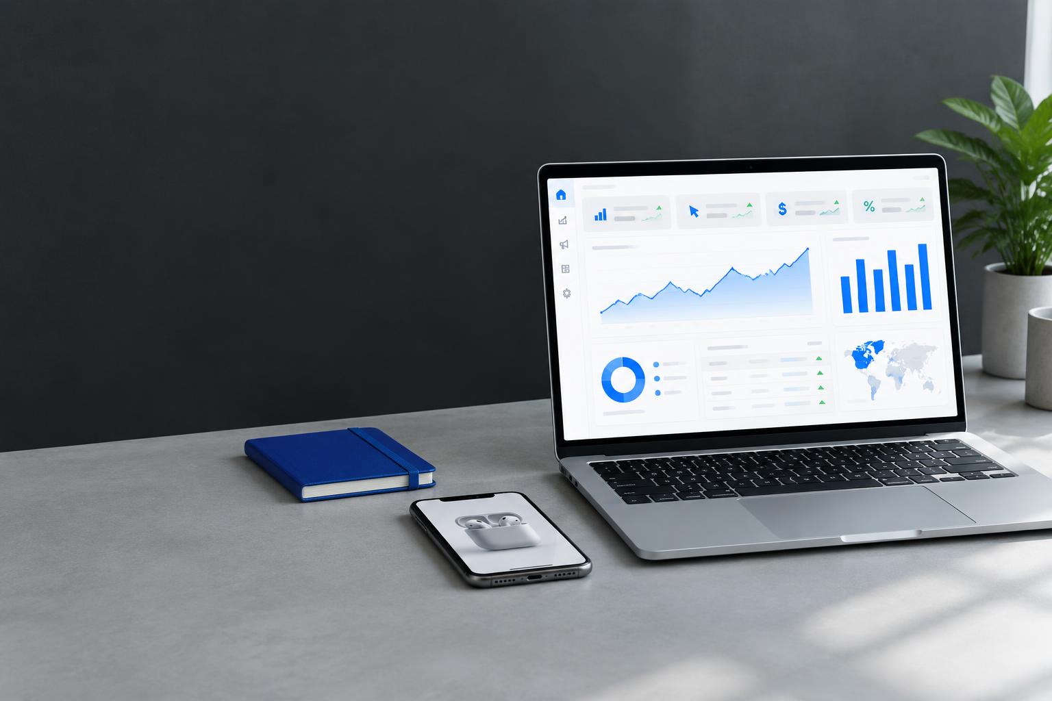 An advertising workspace with a laptop and campaign charts